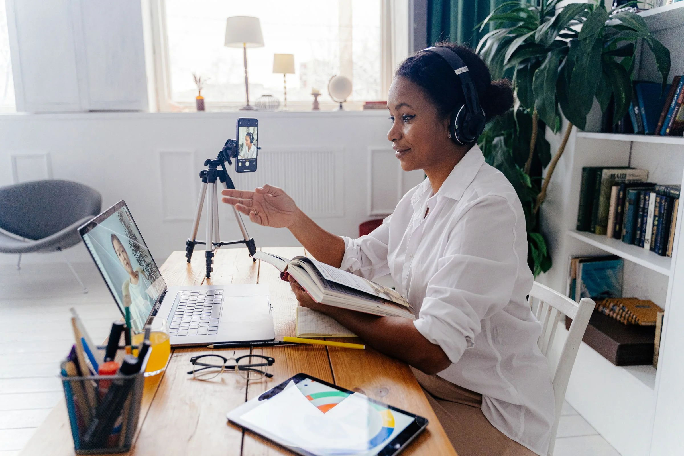 A tutor teaching an online lesson from her home study